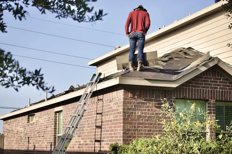 Professional roofer working on a residential roof in Harborgate